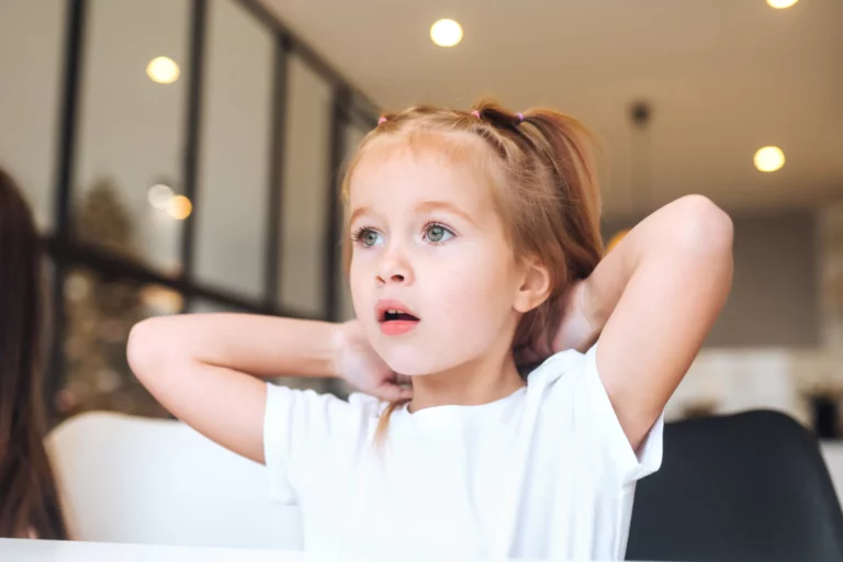 little girl with a surprised look on her face as she watches television